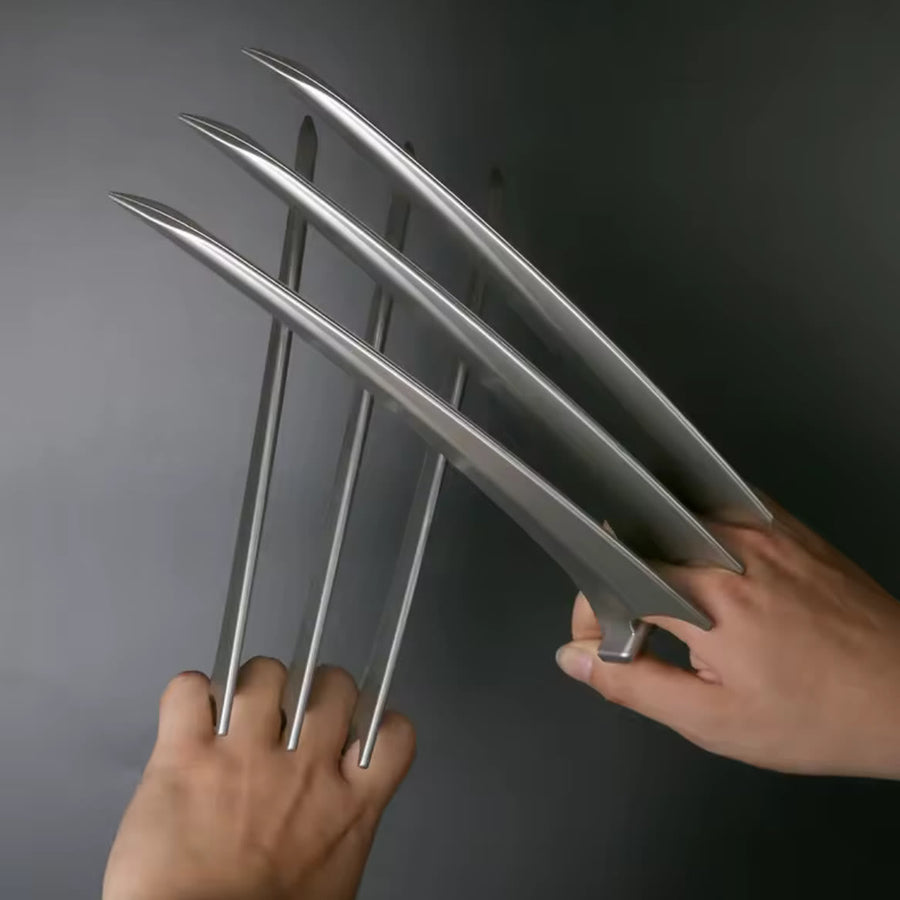Both ClawX pairs worn on two hands, blades fully extended