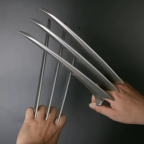 Both ClawX pairs worn on two hands, blades fully extended