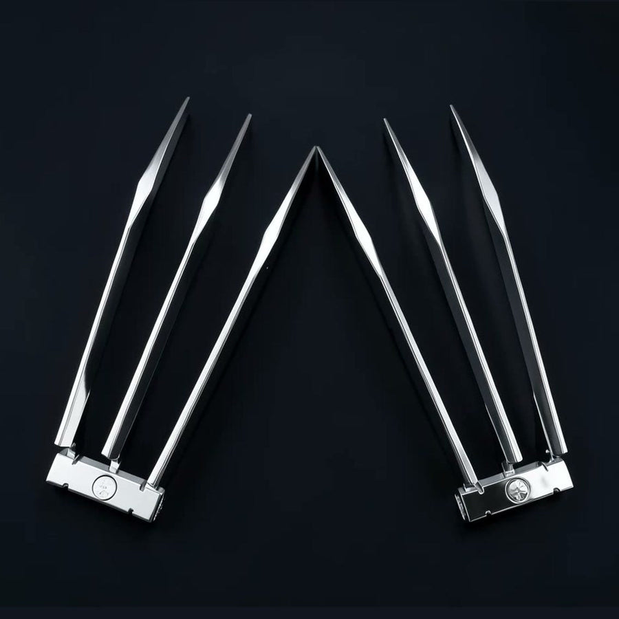 A pair of ClawX folding claws held open in one hand