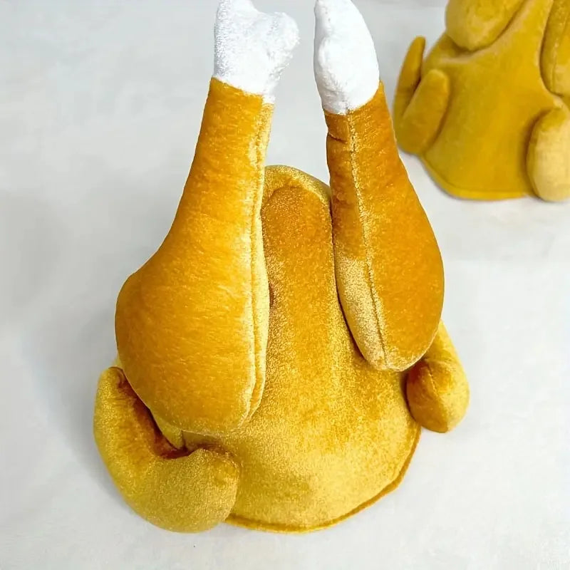 Close up of the roast turkey hat, two plush drumsticks with white bone tips